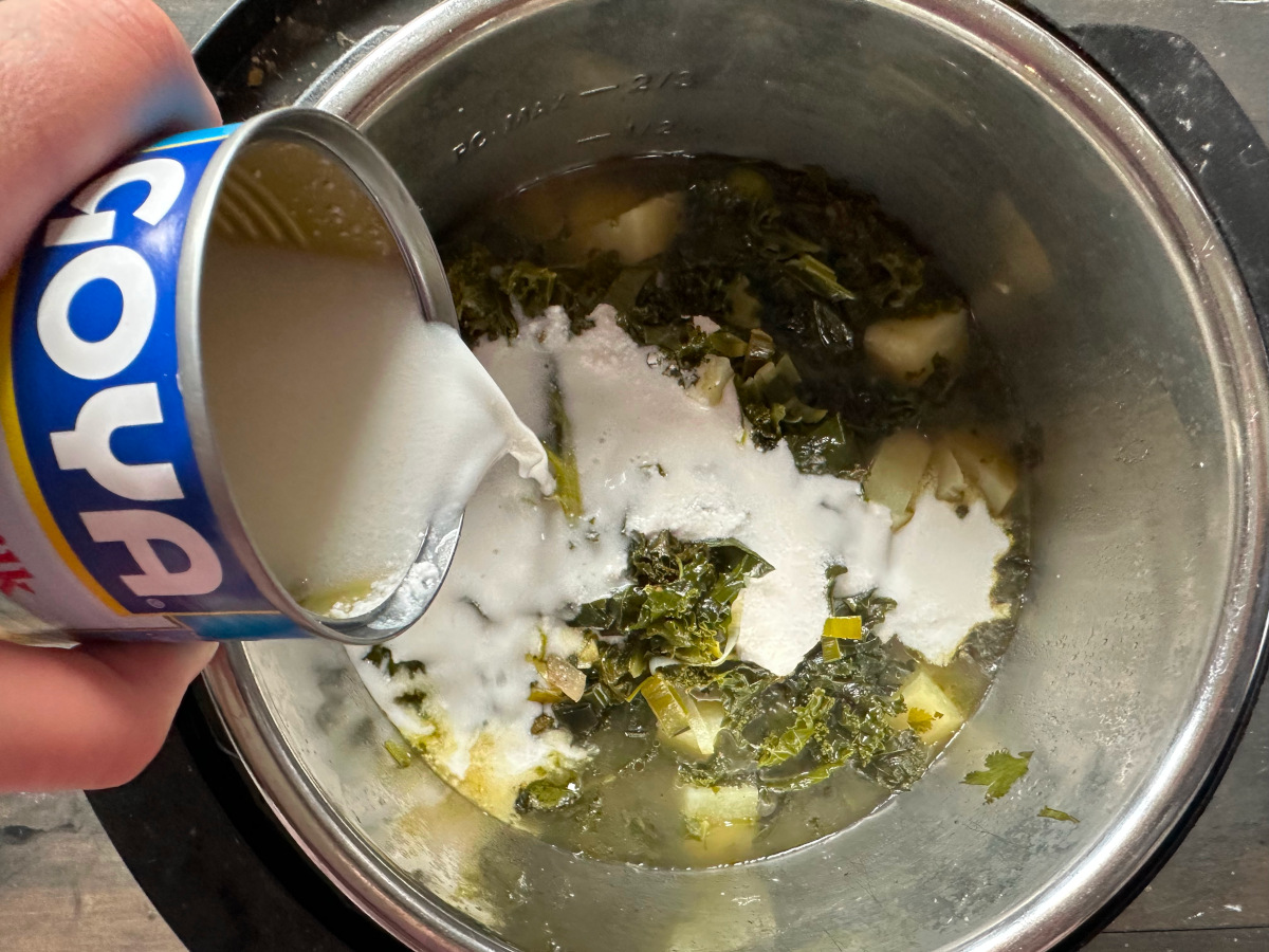 Adding the coconut milk to the soup.