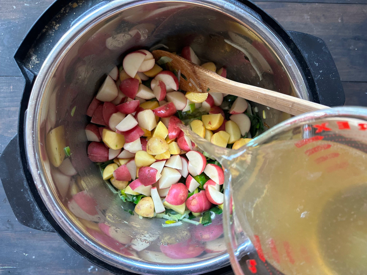 Pouring the broth into the mixture.