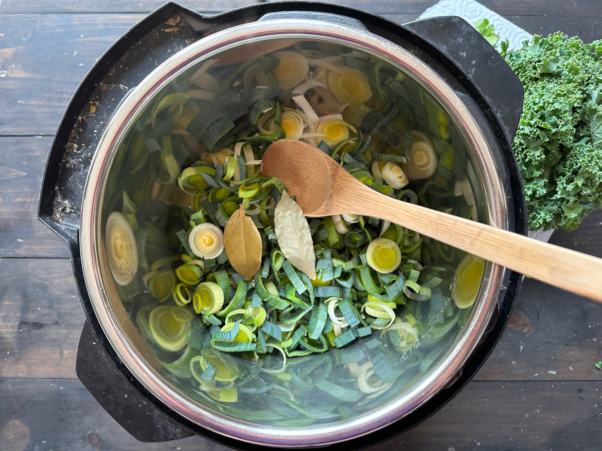 The leeks, garlic, and bay leaves being sauteed in the Instant Pot.