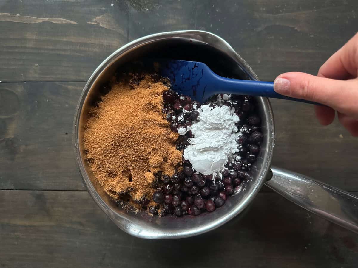 The blueberry filling being mixed together with a rubber spatula.
