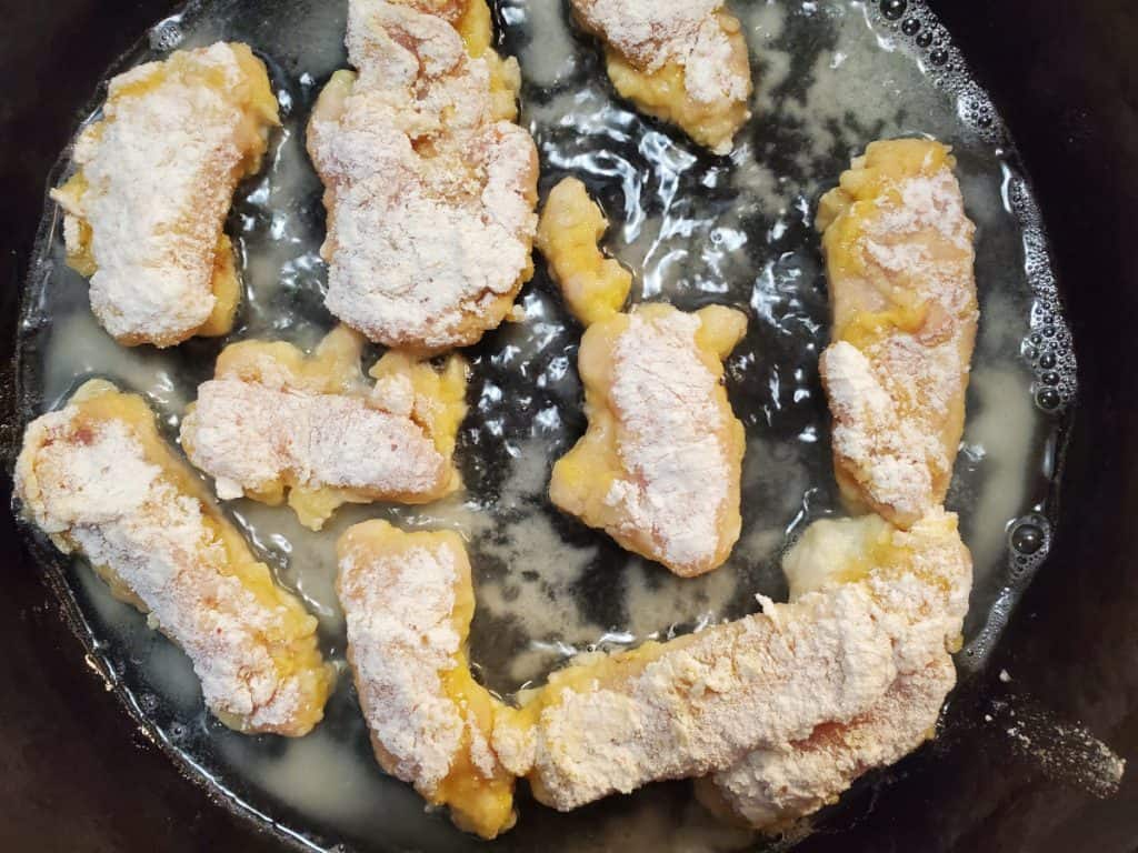 chicken tenders frying in a pan