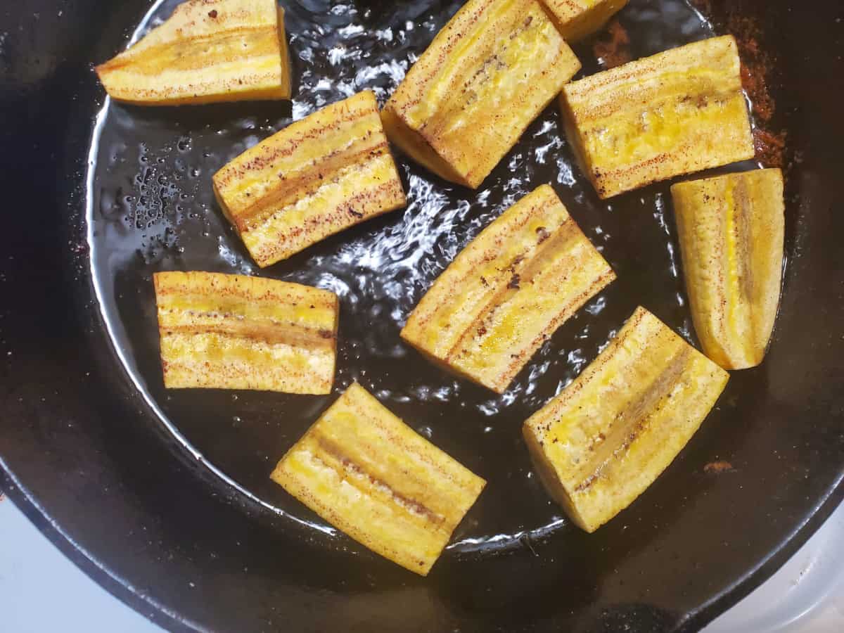 The plantains flipped and frying on the other side.