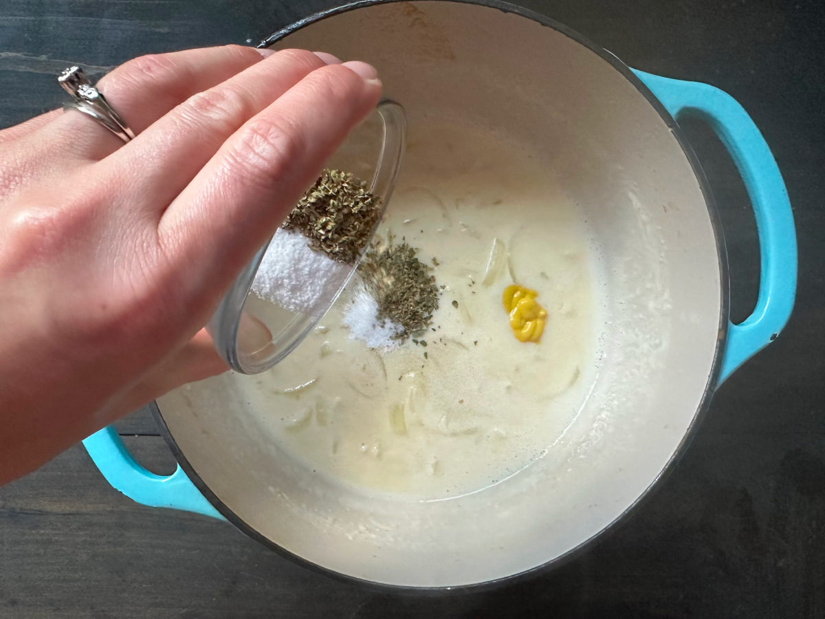 The mustard, lemon juice, and spices added to the onion mixture.