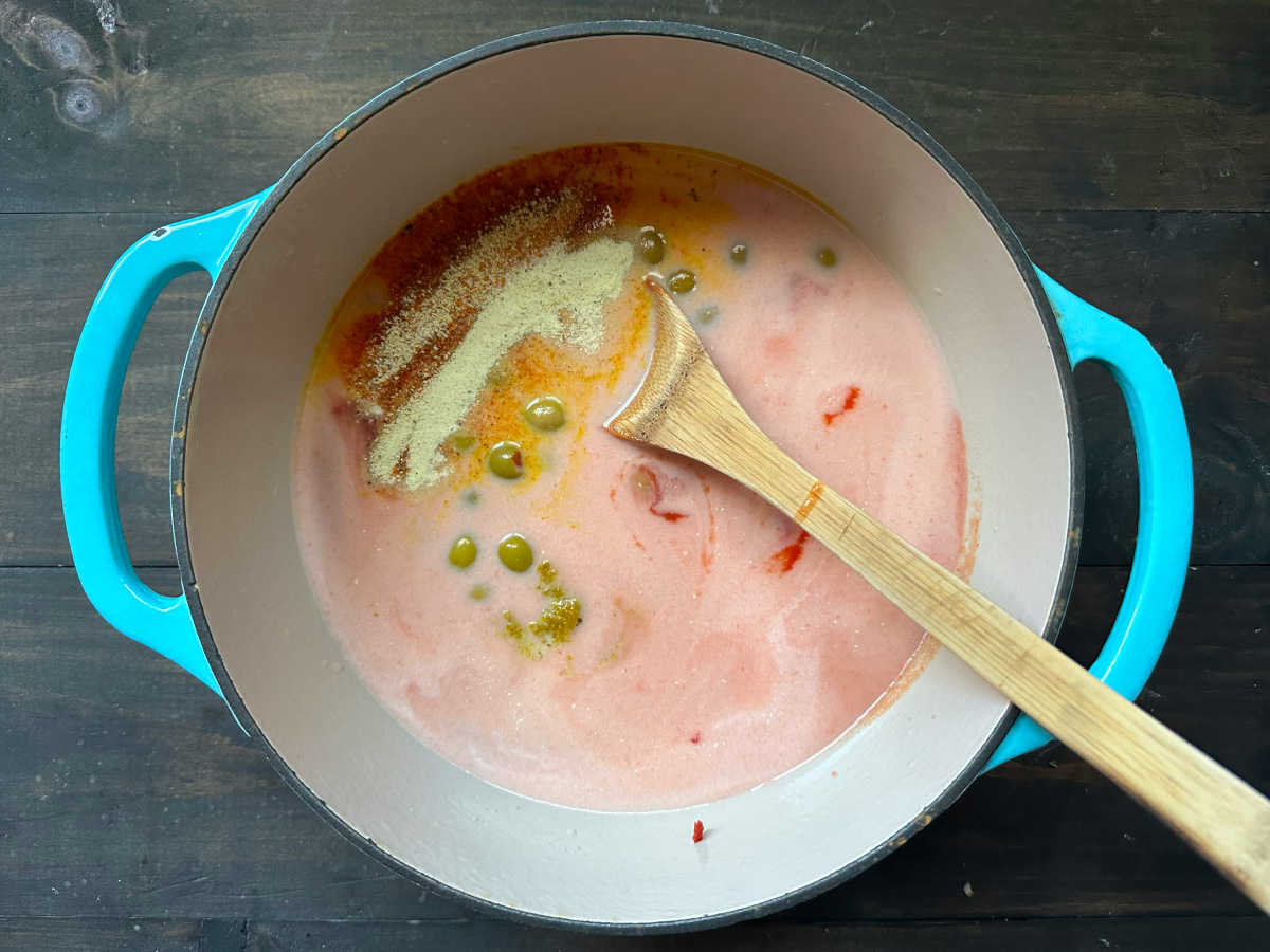 The sauce ingredients in a pot with a spoon to be cooked.