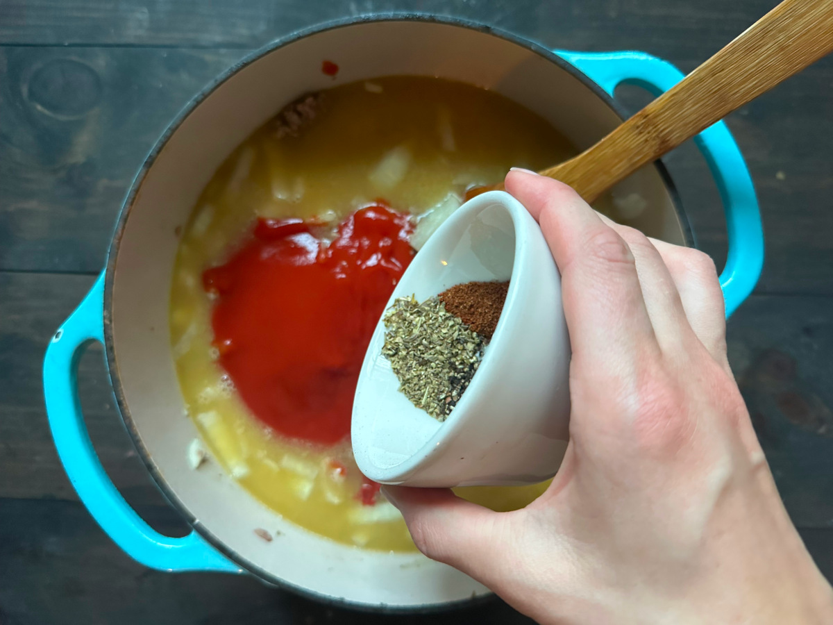 Adding spices to the pot.