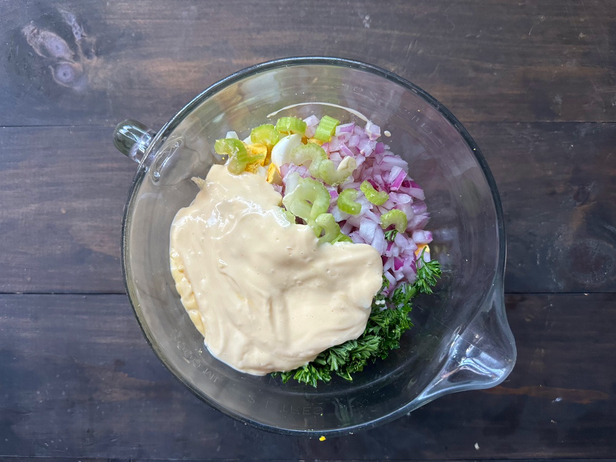 The ingredients in a glass bowl to be mixed.