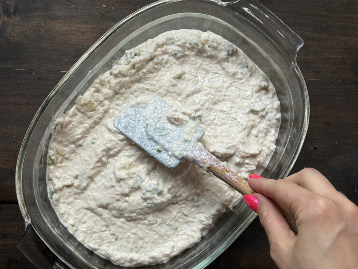 Spreading the mixture into an oven safe dish.
