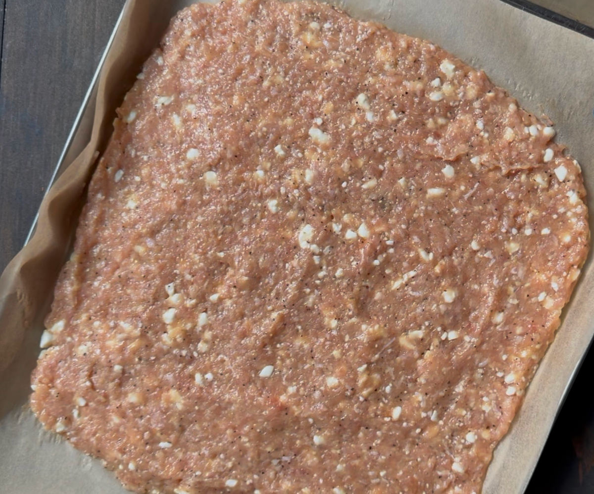 The crust spread out on a parchment lined baking sheet.