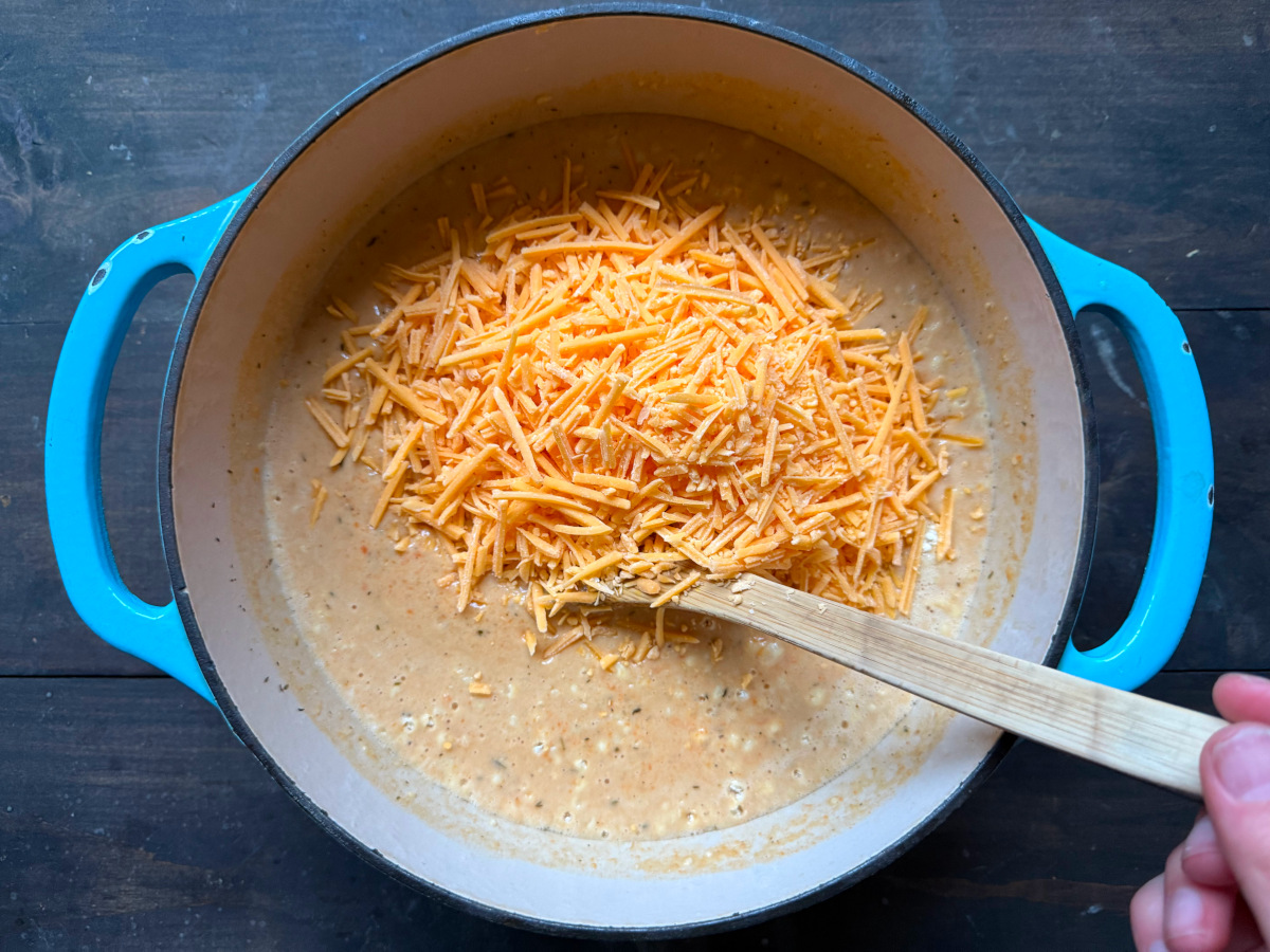 Cheese being stirred into the soup.
